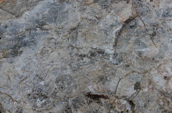 Arkaplan için kullanılacak çatlaklı taş duvarların dokusu.