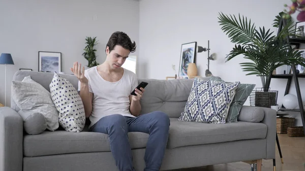 Tense Frustrated Man Reaction, while Using Smartphone