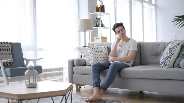 Pensive Young Man Thinking While Sitting Sofa Home — Stock Photo, Image