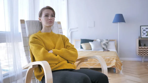 Young Woman Sitting on Casual Chair, Brainstorming