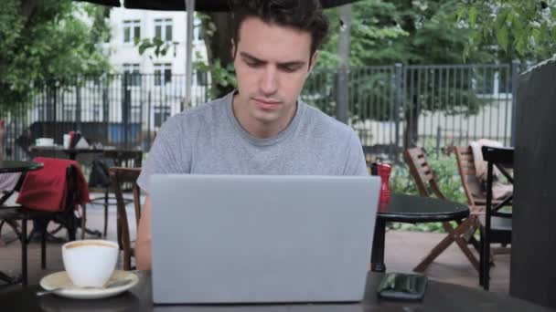 Hombre Usando Smartphone y Trabajando en Laptop en Café Terraza — Vídeos de Stock