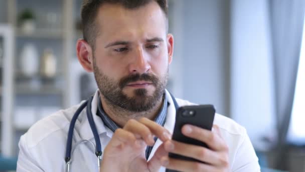 Doctor Browsing on Smart Phone — Stock Video
