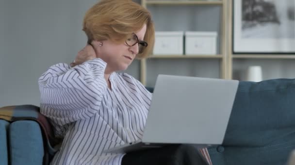 Vieille femme âgée avec douleur au cou travaillant sur ordinateur portable — Video