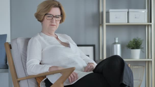 Serious Old Senior Woman Sitting on Couch in Bedroom Looking at Camera — Stock Video