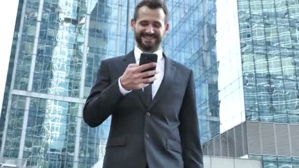 Walking Businessman Using Smartphone — Stock Video