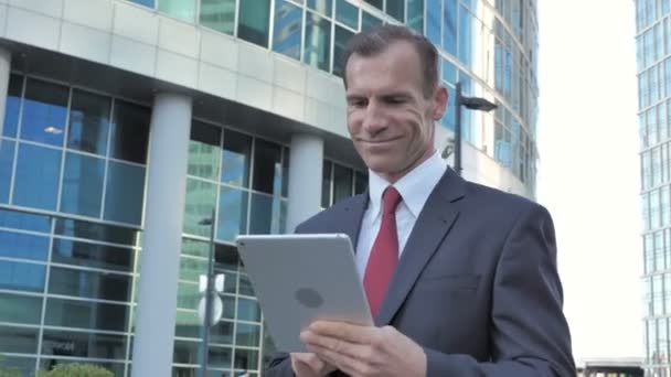 Walking Businessman Using Tablet Browsing Online — Stock Video