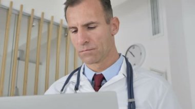 Doktor laptopta çalışıyor.