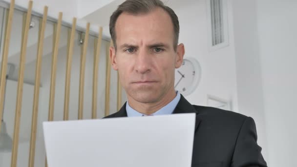 Pensive Middle Aged Businessman Reading Documents Office Paperwork — Stock Video