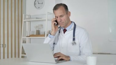 Doktor hasta ile telefonda konuşurken, tıbbi rapor tartışıyor