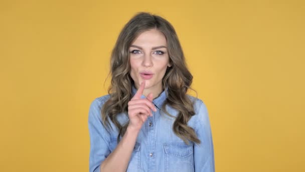 Young Girl Gesturing Silence Finger Lips Yellow Background — Stock Video
