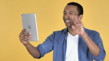 Sarı arka plan üzerinde izole Tablet ile Afrika delikanlı tarafından görüntülü sohbet