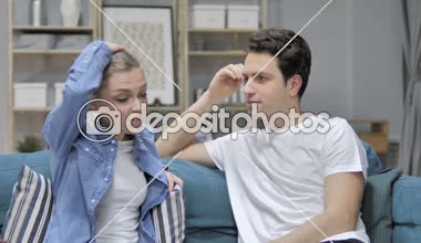Fighting Couple Arguing while Sitting on Couch