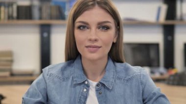 Inviting Gesture by Young Woman at Work