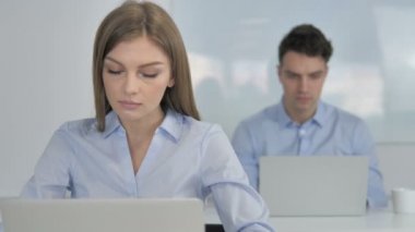 Smiling Young Businesswoman Looking at Camera in Office