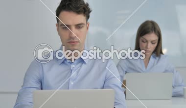 Thumbs Down by Young Businessman in Office