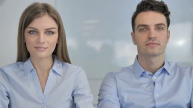 Young Business People Looking at Camera in Office, Colleagues