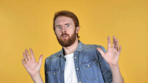 Redhead Man Confused and Scared of Problems Isolated on Yellow Background