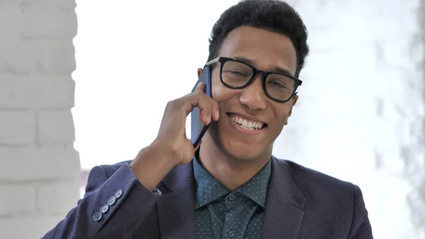 African Man Talking on Phone at Work