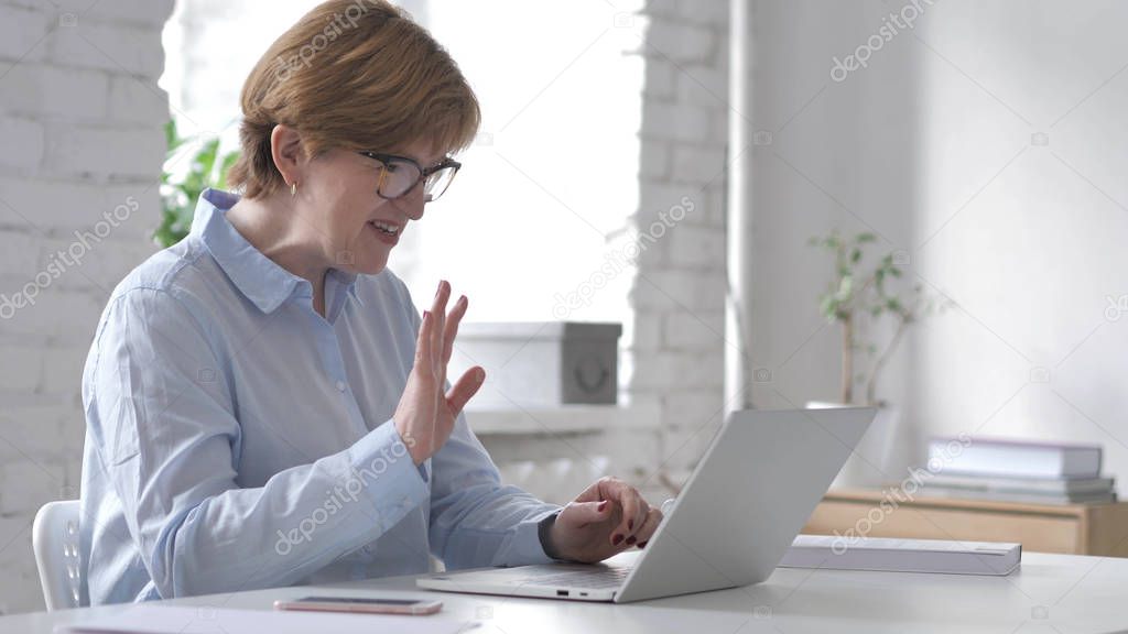 Online Video Chat on Laptop at Work by Woman
