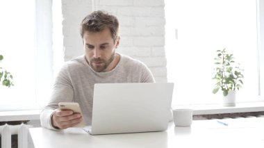 Laptop ve Smartphone ofiste çalışan rahat tasarımcı