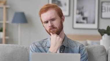 Dalgın sakallı adam düşünme kullanarak Laptop süre