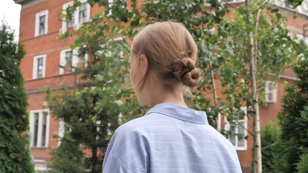 Back View of Woman Walking on Street in Slow Motion