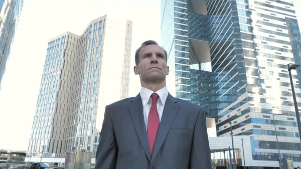 Positive Businessman Standing Outside Office Building