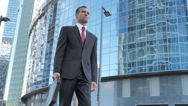 Serious Businessman Walking Near Office Building