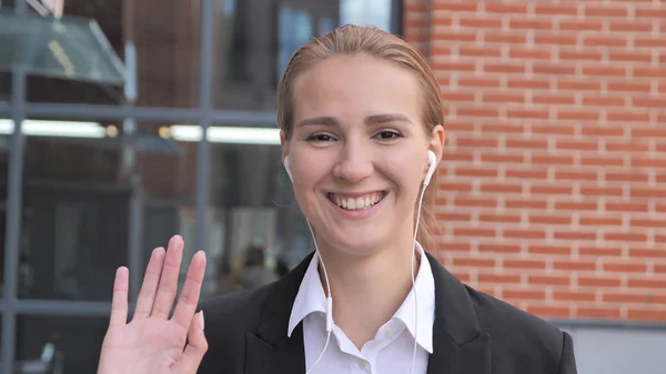 Young Businesswoman Waving Hand Ouside Office