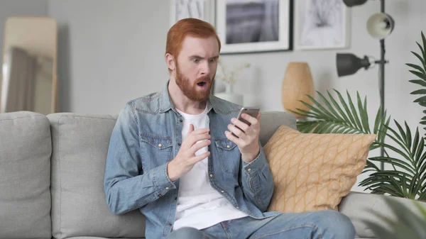 Astonished Man Shocked by Result on Smartphone, Wondering