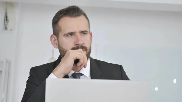 Pensive Businessman Thinking New Idea at Work