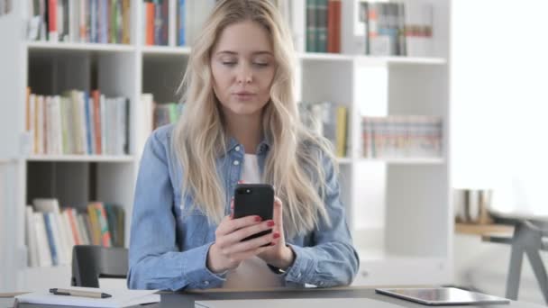 Young Woman in Shock while Using Smartphone — Stock Video