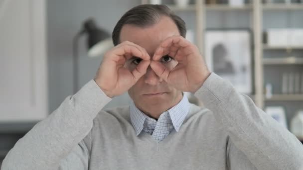 Handgemachte Fernglasgeste eines Mannes mittleren Alters auf der Suche nach einer neuen Chance — Stockvideo