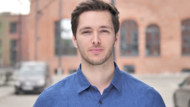 Outdoor Portrait of Smiling Young Man Looking at Camera — Stock Video