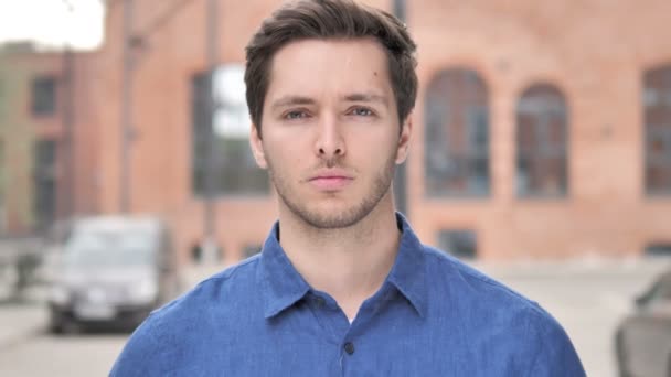 Outdoor Portrait of Sad Young Man Looking at Camera — Stock Video