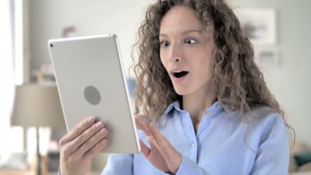 태블릿에 성공을 축하하는 곱슬 머리 여자 — 비디오