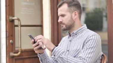 Akıllı telefon kullanırken kayıp tarafından adam üzgün