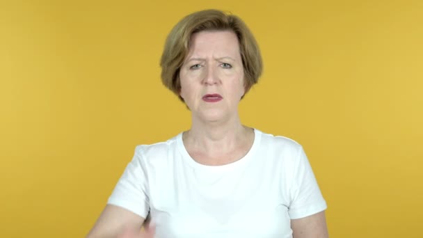 Gammal kvinna söker ny chans, gul bakgrund — Stockvideo