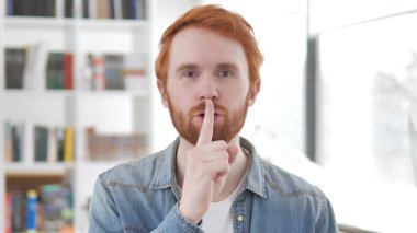 Fingers üzerinde dudaklar tarafından genç Casual Redhead adam, Silence lütfen
