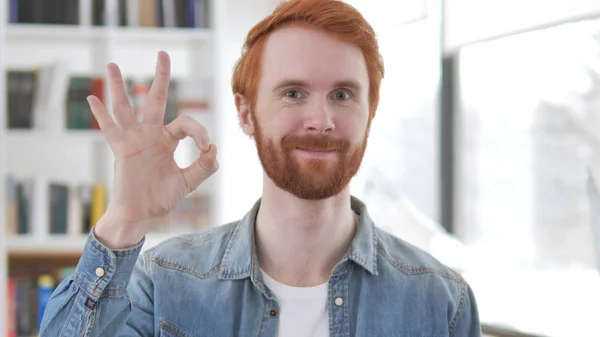 Young Casual Redhead Man Showing Sign of Okay