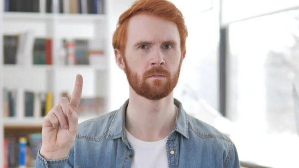 Young Casual Redhead Man Waving Finger to Reject
