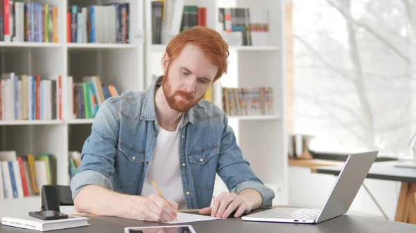 Young Casual Redhead Man Writing Letter