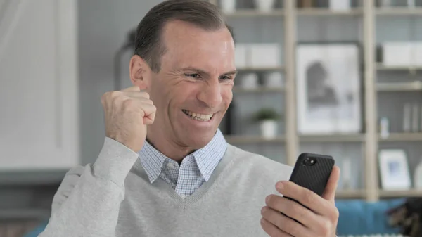 Excited Man Enjoying Success while Using Smartphone — Stock Photo, Image