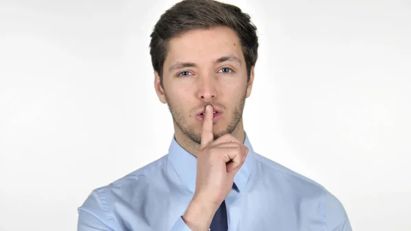 Vinger op lippen door jonge zakenman geïsoleerd op witte achtergrond — Stockfoto