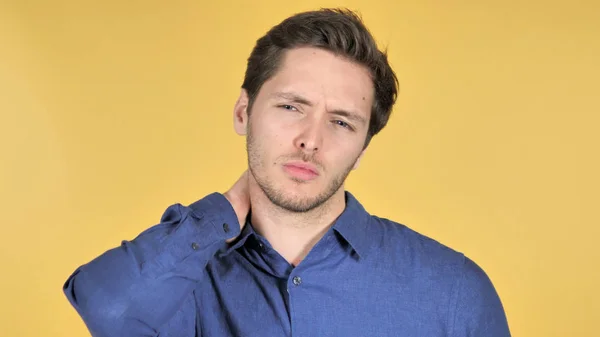 Casual Young Man with Neck Pain on Yellow Background — Stock Photo, Image