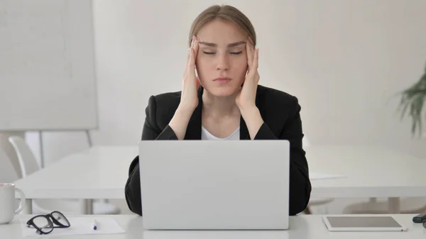 Stressed Young Businesswoman with Headache Working on Laptop