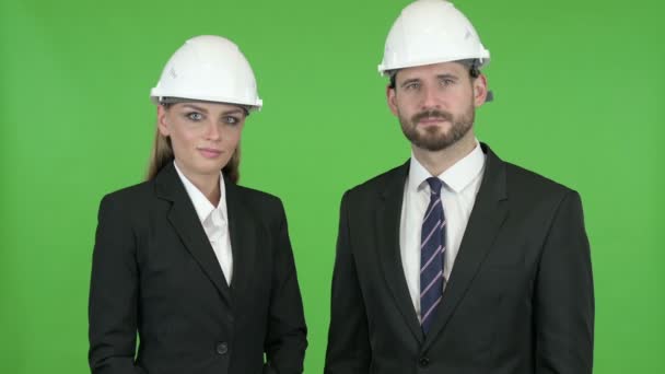 Engineers Posing with Piggy Bank and Construction Equipment Against Chroma Key — Stock Video