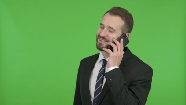 Young Businessman Talking on his Cellphone against Chroma Key — Stock Video