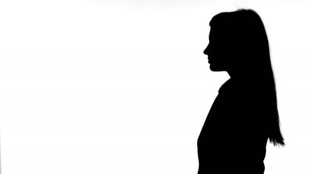 Silhouette eines jungen Paares, das sich vor weißem Hintergrund umarmt — Stockvideo
