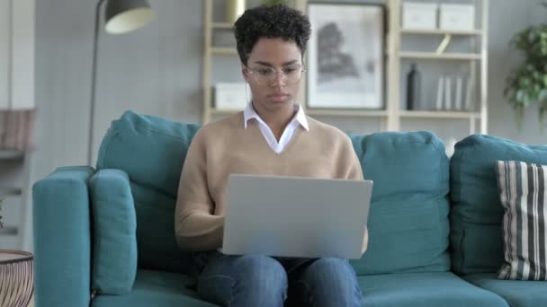 Young African Girl Coughing while working on laptop — Stock Video